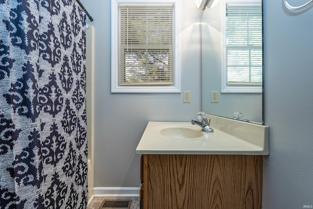 bathroom with a shower with curtain and vanity