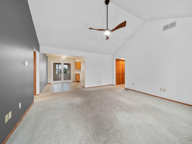 unfurnished living room featuring french doors, light colored carpet, ceiling fan, and high vaulted ceiling