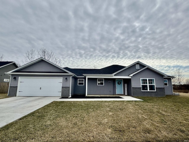 single story home featuring a garage and a front lawn