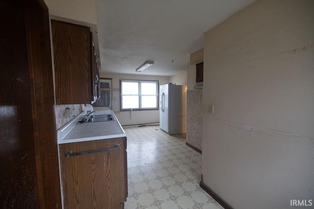 kitchen with white refrigerator and sink