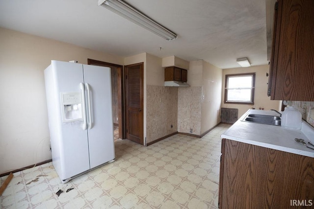 kitchen featuring sink and white fridge with ice dispenser