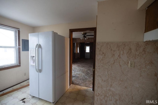 kitchen featuring light colored carpet, electric panel, white fridge with ice dispenser, and ceiling fan