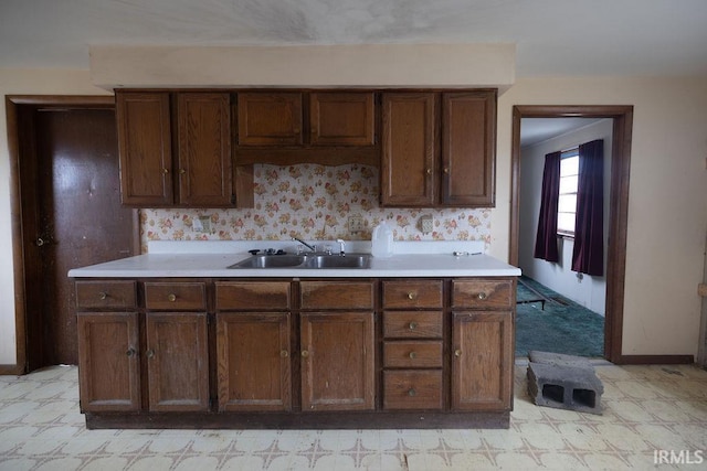 kitchen featuring dark brown cabinets and sink