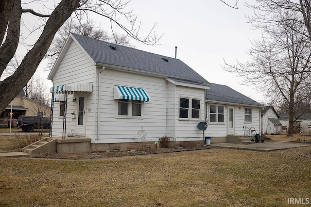 rear view of house with a yard