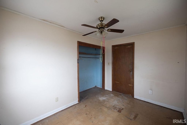 unfurnished bedroom featuring crown molding, ceiling fan, and a closet