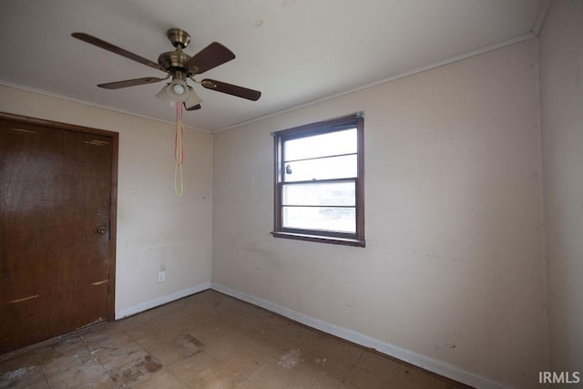 spare room with crown molding and ceiling fan