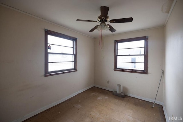 unfurnished room featuring crown molding, ceiling fan, and plenty of natural light