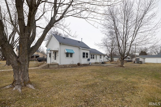 rear view of property featuring a lawn