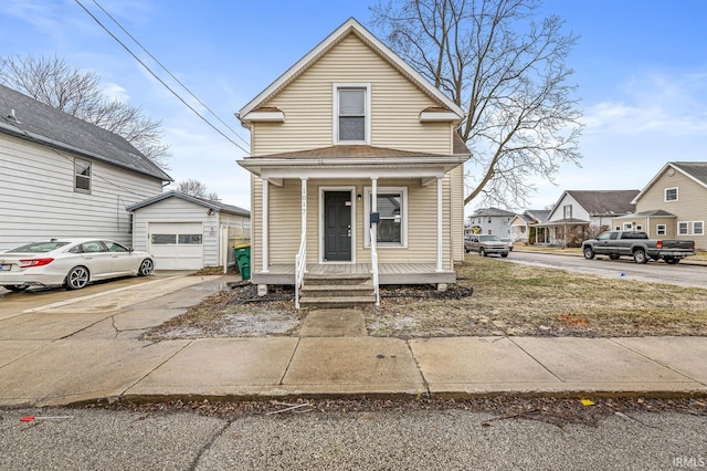 view of front of home featuring a garage, an outdoor structure, and covered porch