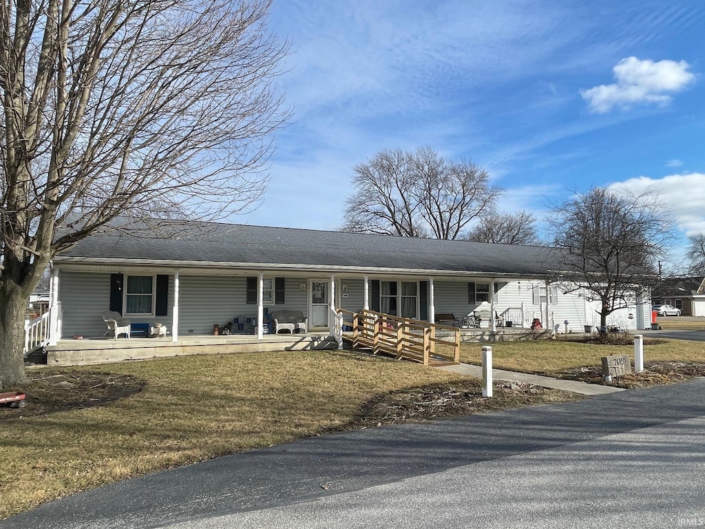 ranch-style house with a porch and a front lawn