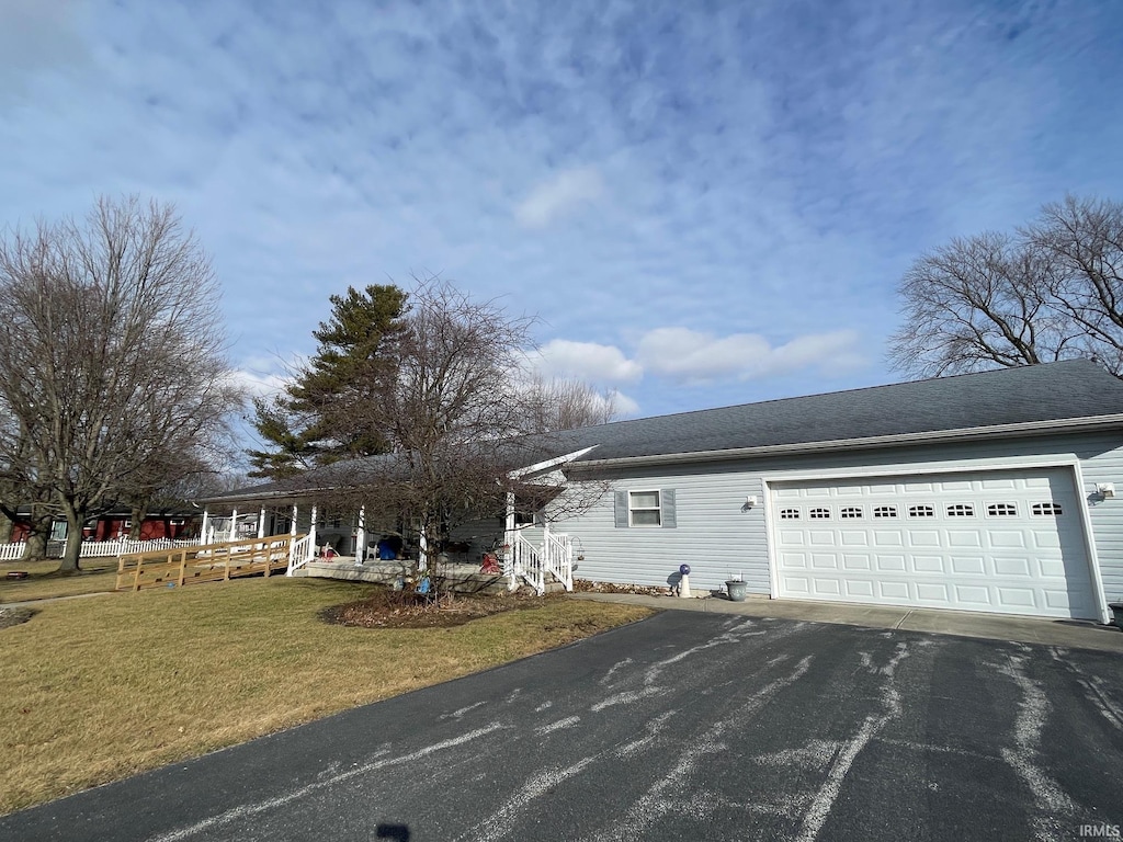 exterior space featuring a garage and a front lawn