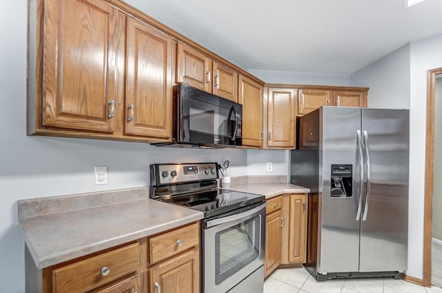 kitchen with stainless steel appliances and light tile patterned flooring