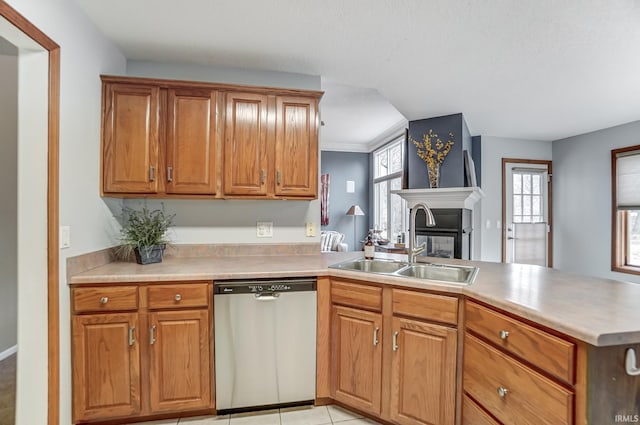 kitchen with sink, stainless steel dishwasher, light tile patterned floors, and kitchen peninsula