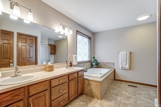 bathroom with tile patterned floors, vanity, and separate shower and tub