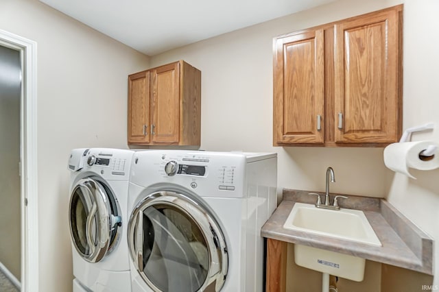 laundry area with cabinets, sink, and independent washer and dryer