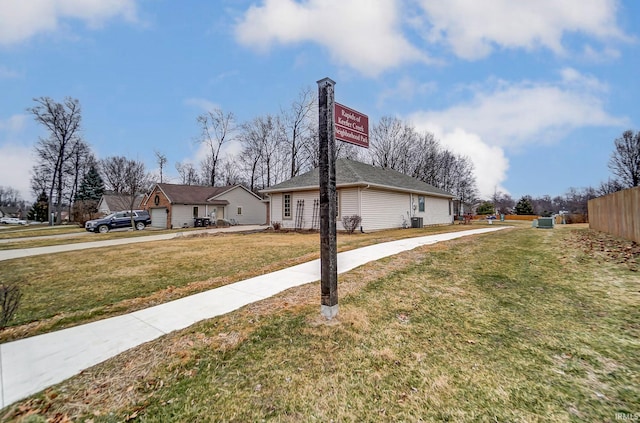 view of side of property with a lawn