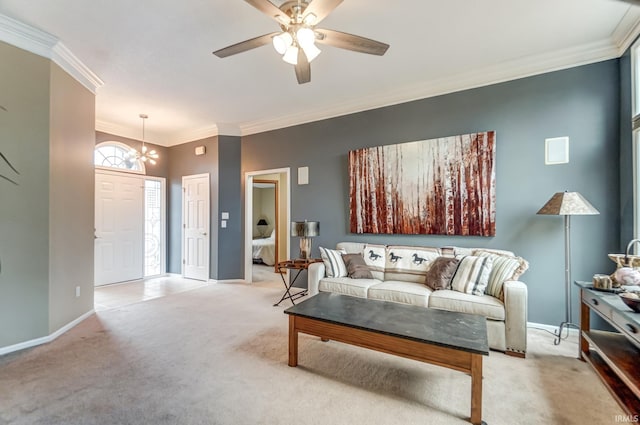 living room with ornamental molding, ceiling fan with notable chandelier, and light colored carpet