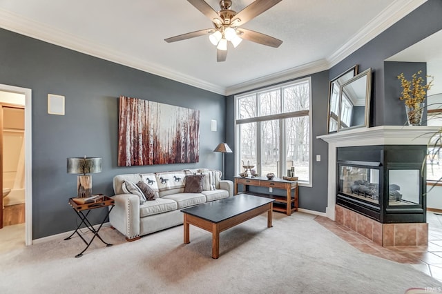 carpeted living room with crown molding, a multi sided fireplace, and ceiling fan