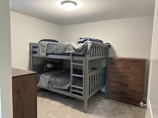 carpeted bedroom featuring a textured ceiling