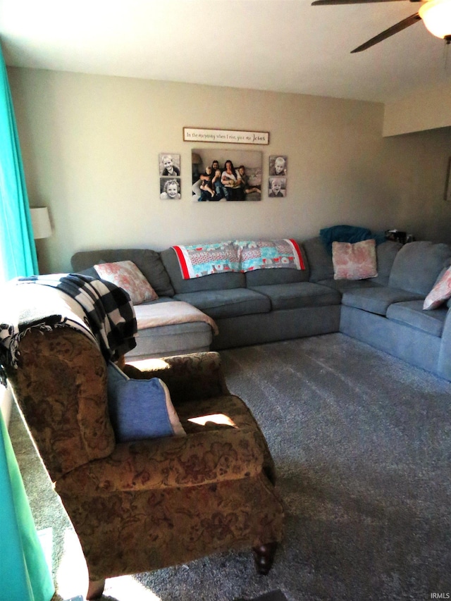 living room with ceiling fan and carpet