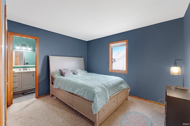 bedroom featuring light carpet, baseboards, and a sink