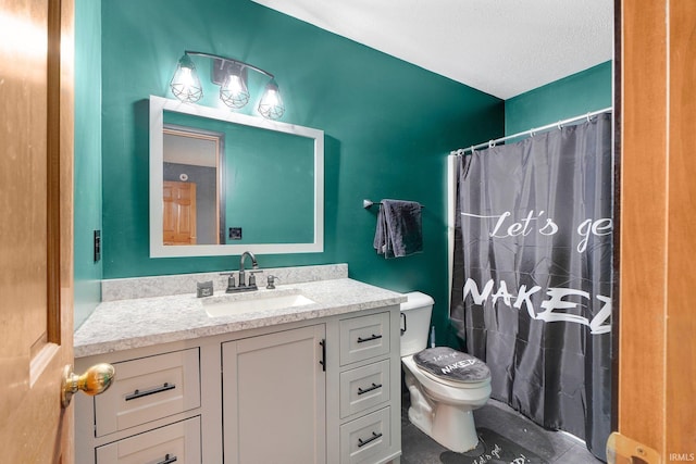 bathroom featuring a shower with shower curtain, toilet, vanity, a textured ceiling, and tile patterned flooring