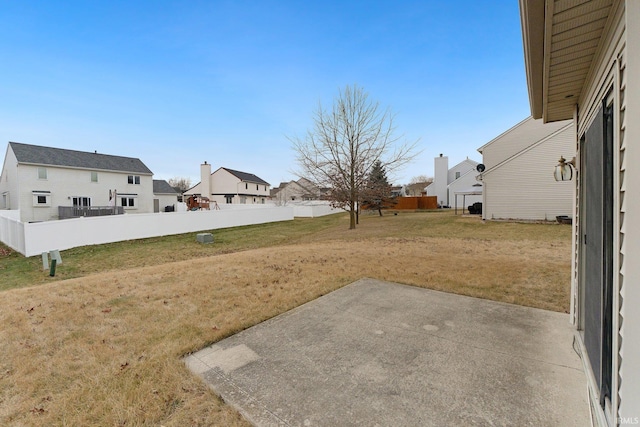 view of yard featuring a residential view, a patio, and fence