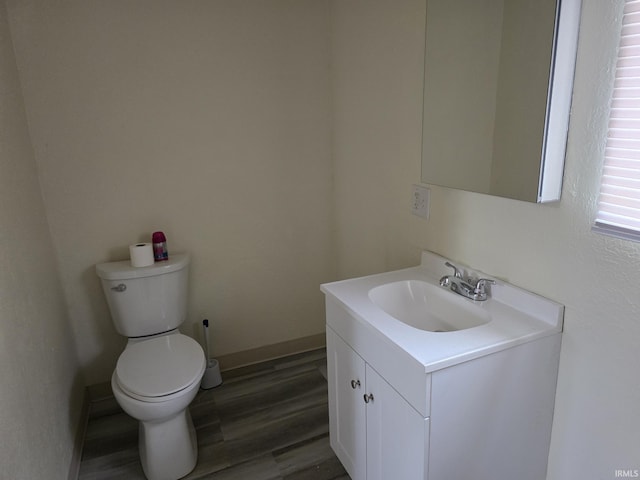 bathroom featuring vanity, toilet, and wood-type flooring