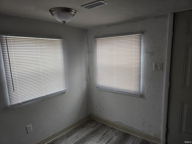 spare room featuring hardwood / wood-style flooring