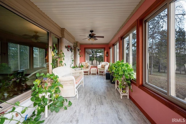 unfurnished sunroom with ceiling fan