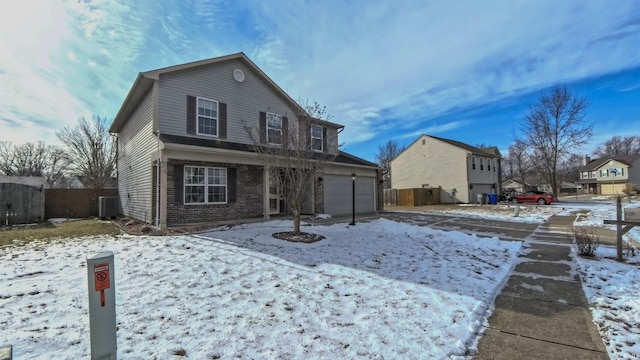 snow covered property with a garage