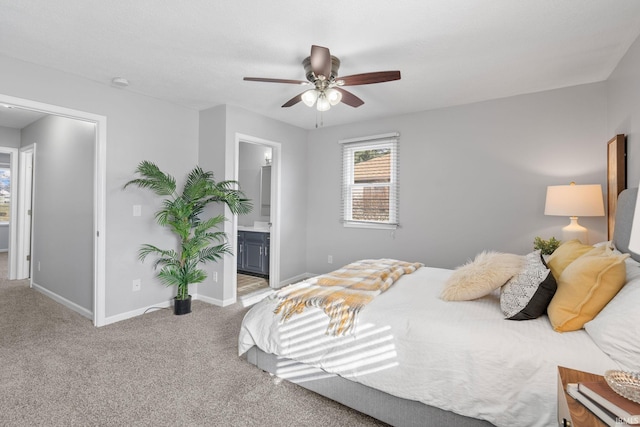 carpeted bedroom with ceiling fan and ensuite bathroom