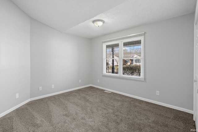 empty room featuring carpet floors and a textured ceiling