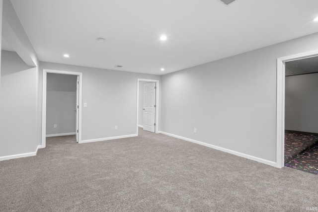 unfurnished bedroom featuring a walk in closet, a closet, and carpet