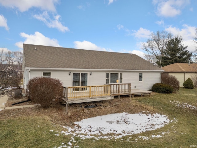 back of property with a lawn and a deck