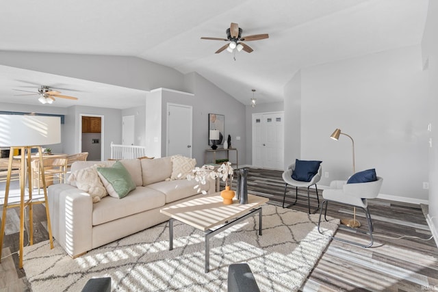 living room featuring hardwood / wood-style flooring, vaulted ceiling, and ceiling fan