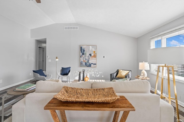 living room featuring lofted ceiling and hardwood / wood-style flooring