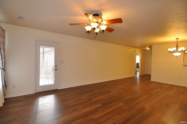 unfurnished living room featuring visible vents, dark wood finished floors, baseboards, and ceiling fan with notable chandelier