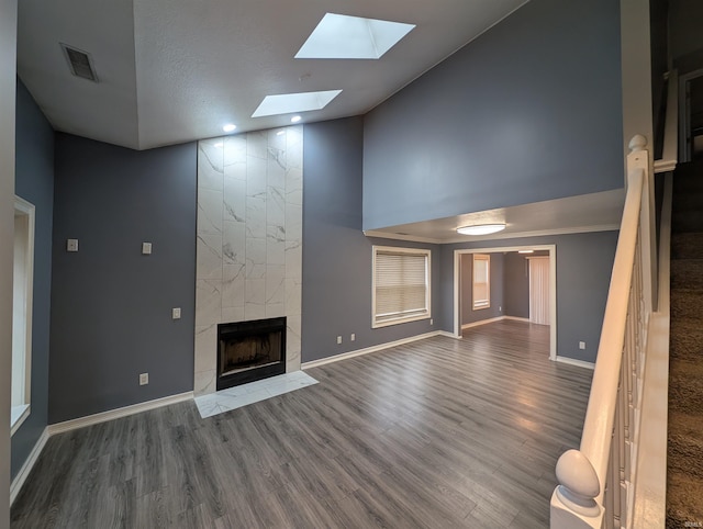 unfurnished living room with a fireplace, high vaulted ceiling, and hardwood / wood-style floors