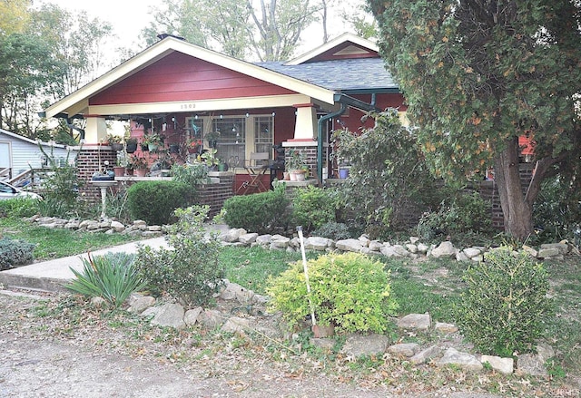 view of front of property with covered porch and brick siding