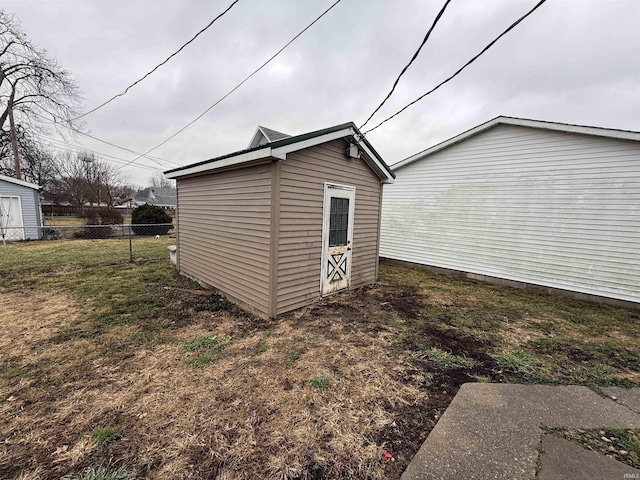 exterior space featuring a yard and a storage unit