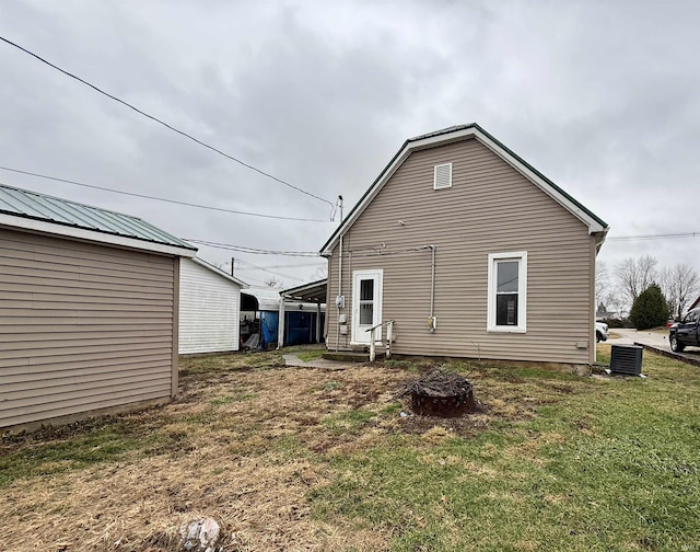 back of house with a yard and cooling unit