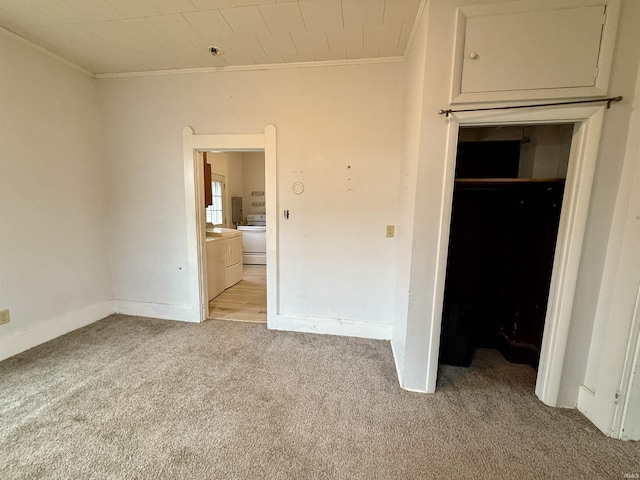 unfurnished bedroom featuring crown molding, light carpet, and ensuite bath