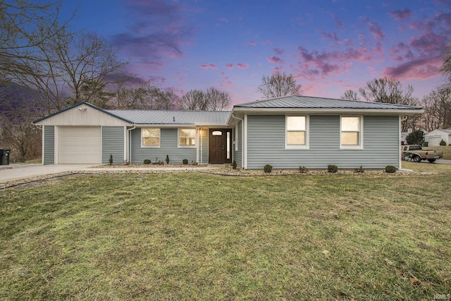 single story home featuring a garage and a lawn