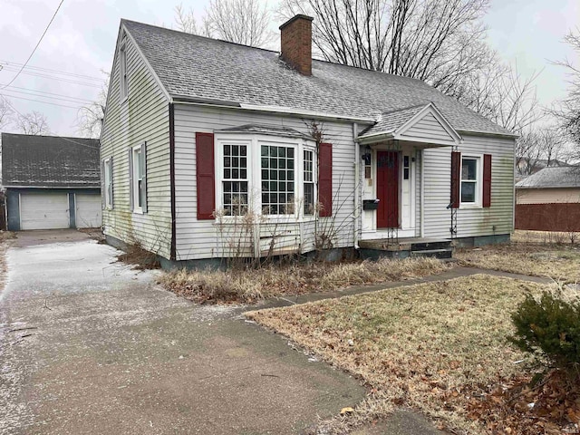 view of front of home featuring a garage and an outdoor structure