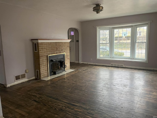 unfurnished living room with dark hardwood / wood-style flooring