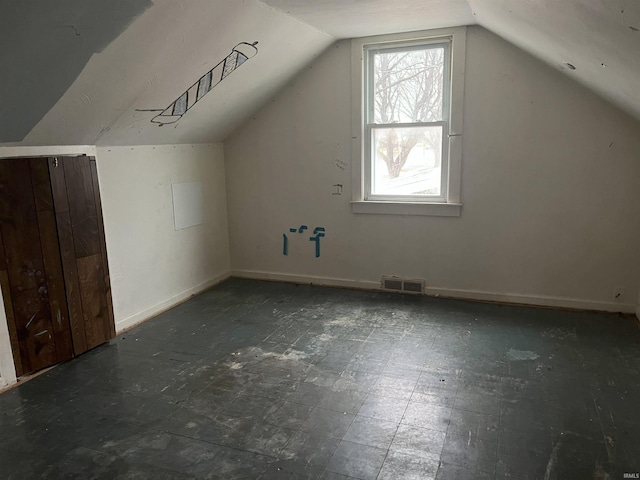 additional living space featuring vaulted ceiling