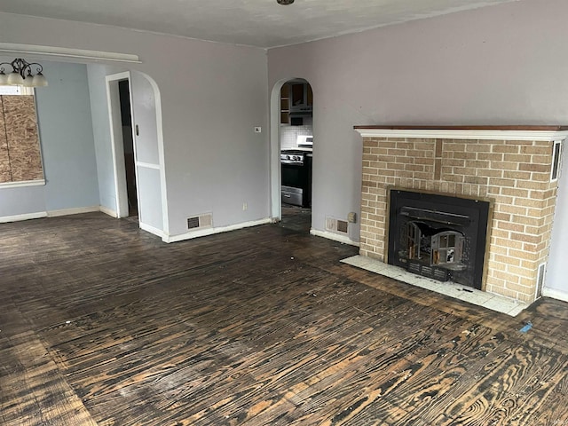 unfurnished living room with a fireplace and dark hardwood / wood-style floors