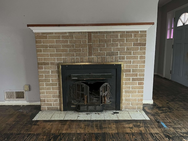 interior details with hardwood / wood-style floors and a fireplace