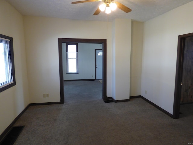 carpeted empty room with ceiling fan